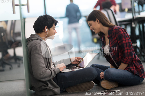 Image of software developers couple working on the floor