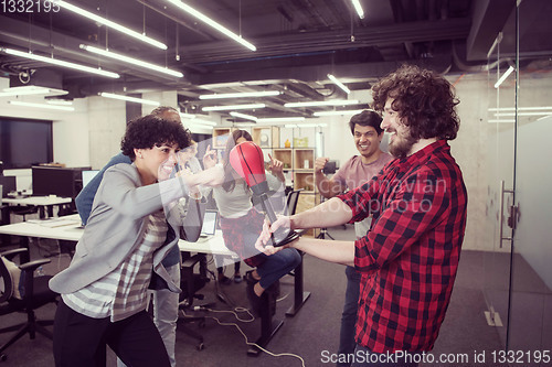 Image of multiethnics business team boxing at office