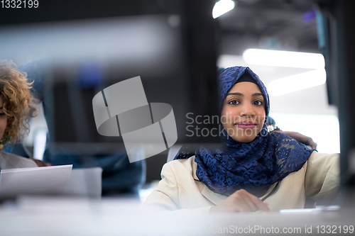 Image of black muslim female software developer at work