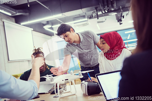 Image of multiethnic business team learning about drone technology