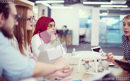 Image of multiethnic business team learning about drone technology