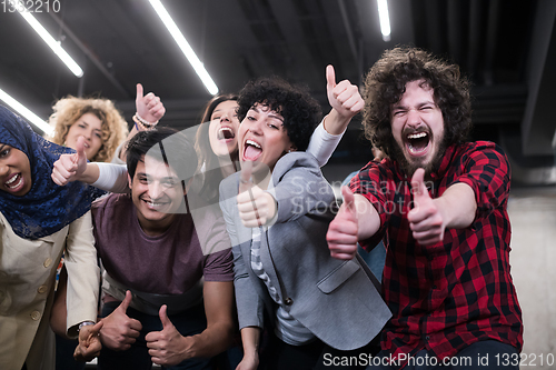 Image of portrait of young excited multiethnics business team