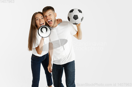 Image of Portrait of beautiful couple football fans on white studio background