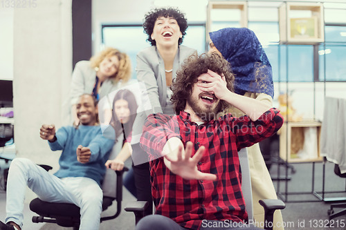 Image of multiethnics business team racing on office chairs