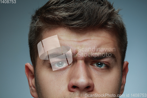 Image of Close-up portrait of young man isolated on grey studio background
