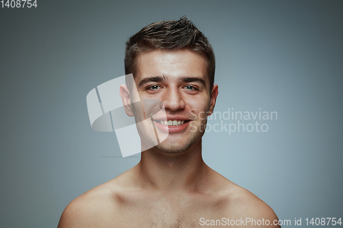 Image of Portrait of shirtless young man isolated on grey studio background