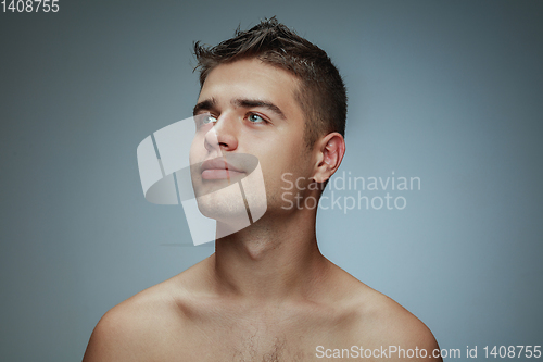 Image of Portrait of shirtless young man isolated on grey studio background