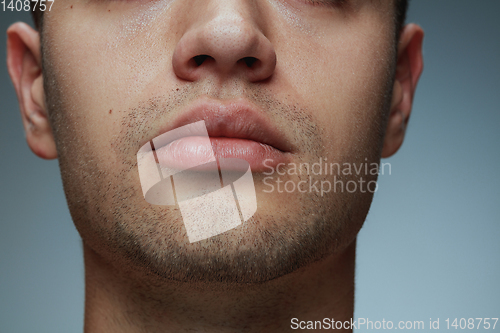 Image of Close-up portrait of young man isolated on grey studio background