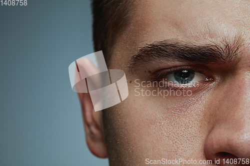 Image of Close-up portrait of young man isolated on grey studio background