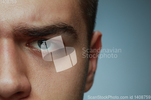 Image of Close-up portrait of young man isolated on grey studio background