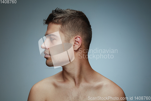 Image of Portrait of shirtless young man isolated on grey studio background