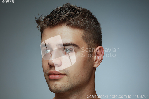 Image of Portrait of shirtless young man isolated on grey studio background