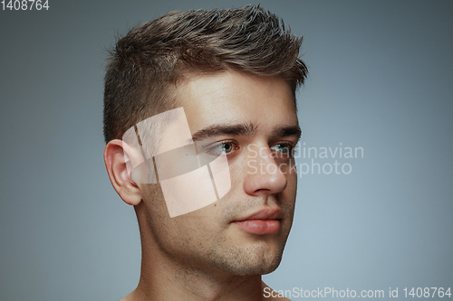 Image of Portrait of shirtless young man isolated on grey studio background