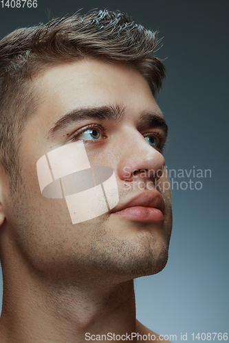 Image of Portrait of shirtless young man isolated on grey studio background