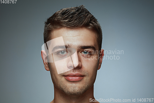 Image of Portrait of shirtless young man isolated on grey studio background