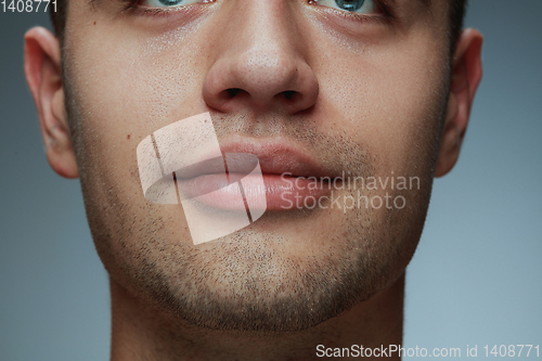 Image of Close-up portrait of young man isolated on grey studio background