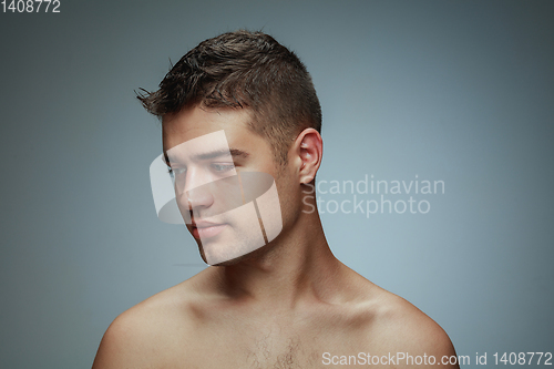 Image of Portrait of shirtless young man isolated on grey studio background