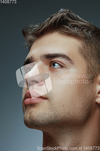 Image of Portrait of shirtless young man isolated on grey studio background