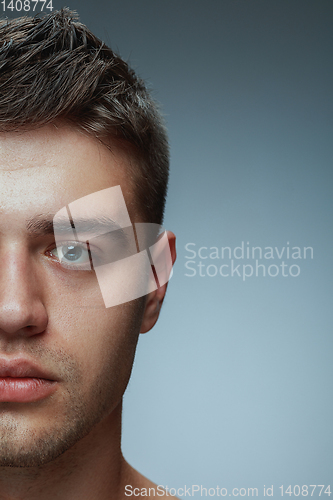 Image of Close-up portrait of young man isolated on grey studio background