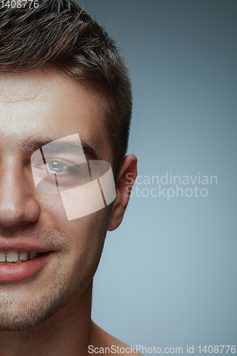 Image of Close-up portrait of young man isolated on grey studio background