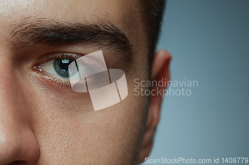 Image of Close-up portrait of young man isolated on grey studio background