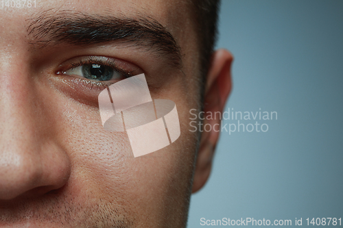 Image of Close-up portrait of young man isolated on grey studio background