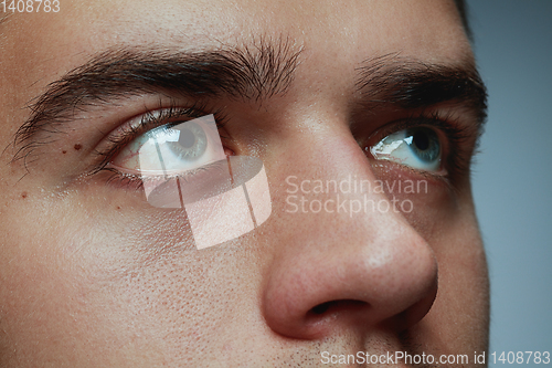 Image of Close-up portrait of young man isolated on grey studio background