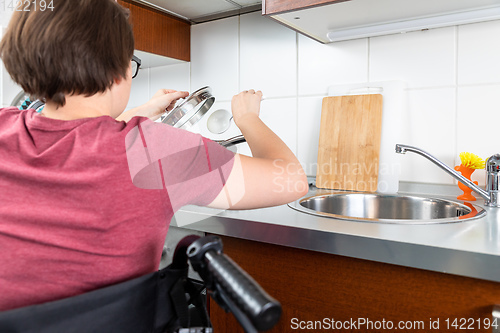 Image of disabled woman cooking in the kitchen