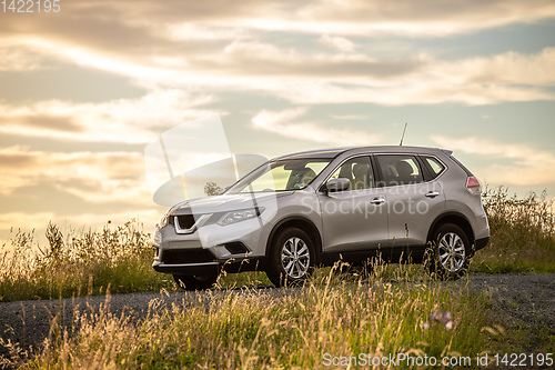 Image of car in the sunset meadow