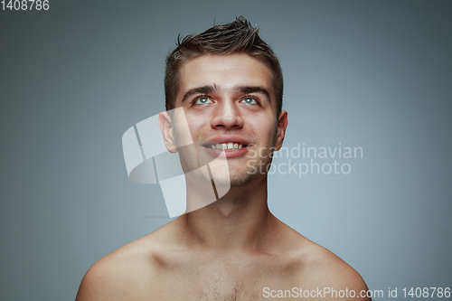 Image of Portrait of shirtless young man isolated on grey studio background