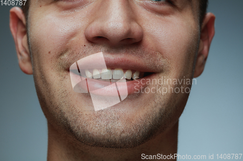 Image of Close-up portrait of young man isolated on grey studio background