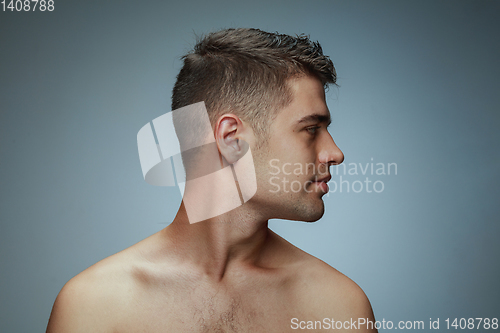 Image of Portrait of shirtless young man isolated on grey studio background