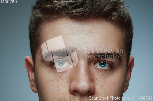 Image of Close-up portrait of young man isolated on grey studio background