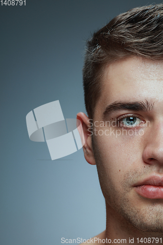 Image of Close-up portrait of young man isolated on grey studio background