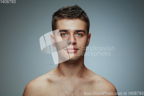 Image of Portrait of shirtless young man isolated on grey studio background