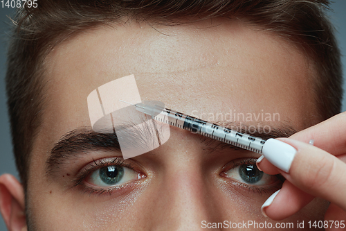 Image of Close-up portrait of young man isolated on grey studio background