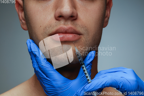 Image of Close-up portrait of young man isolated on grey studio background