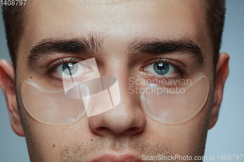 Image of Close-up portrait of young man isolated on grey studio background