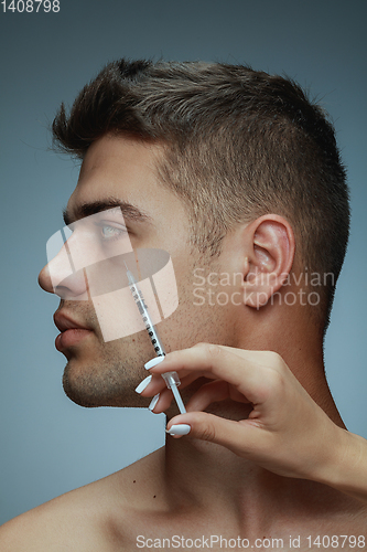 Image of Close-up portrait of young man isolated on grey studio background