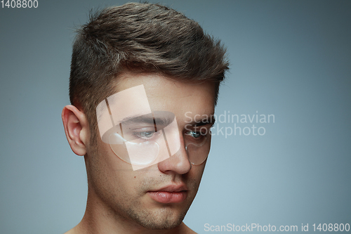Image of Close-up portrait of young man isolated on grey studio background