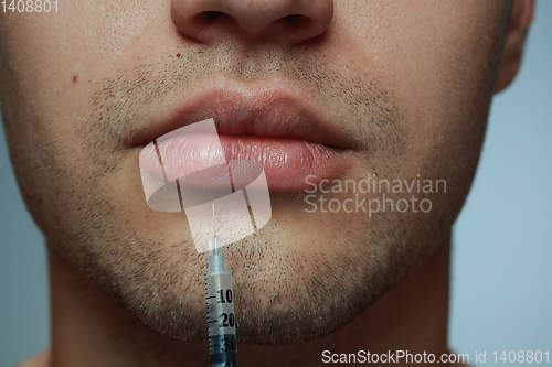 Image of Close-up portrait of young man isolated on grey studio background