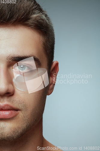Image of Close-up portrait of young man isolated on grey studio background