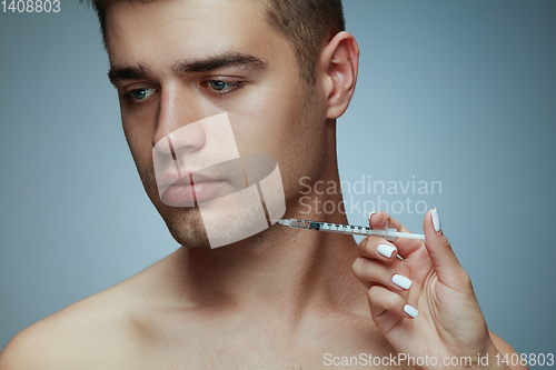 Image of Close-up portrait of young man isolated on grey studio background