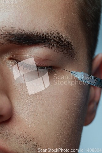 Image of Close-up portrait of young man isolated on grey studio background