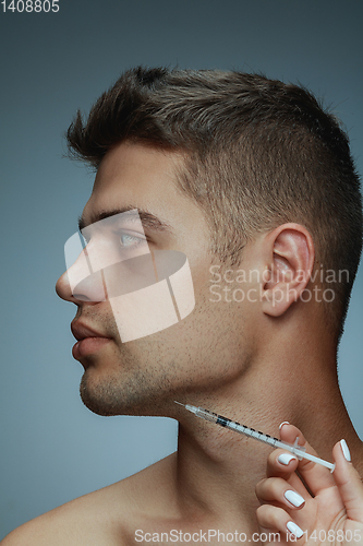 Image of Close-up portrait of young man isolated on grey studio background