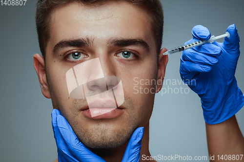 Image of Close-up portrait of young man isolated on grey studio background