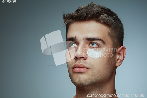 Image of Close-up portrait of young man isolated on grey studio background