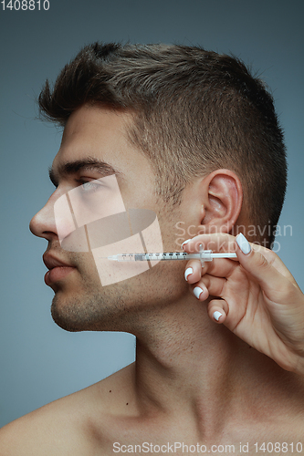 Image of Close-up portrait of young man isolated on grey studio background