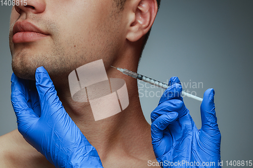 Image of Close-up portrait of young man isolated on grey studio background