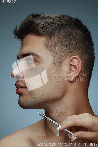 Image of Close-up portrait of young man isolated on grey studio background